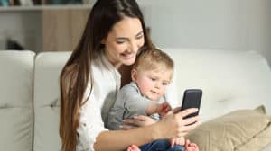 Mother and baby playing with a smart phone