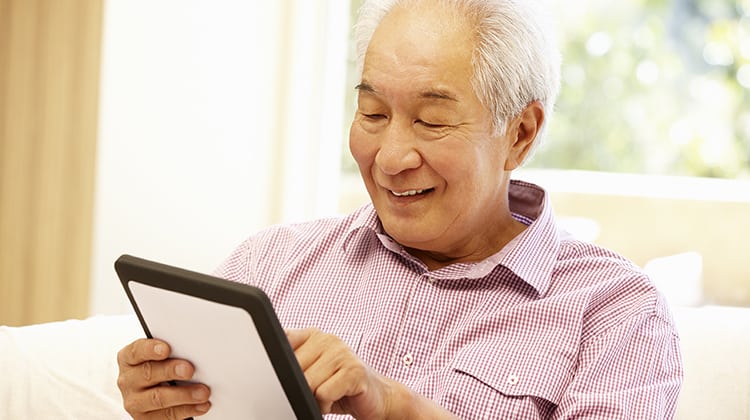 Senior Asian man using tablet