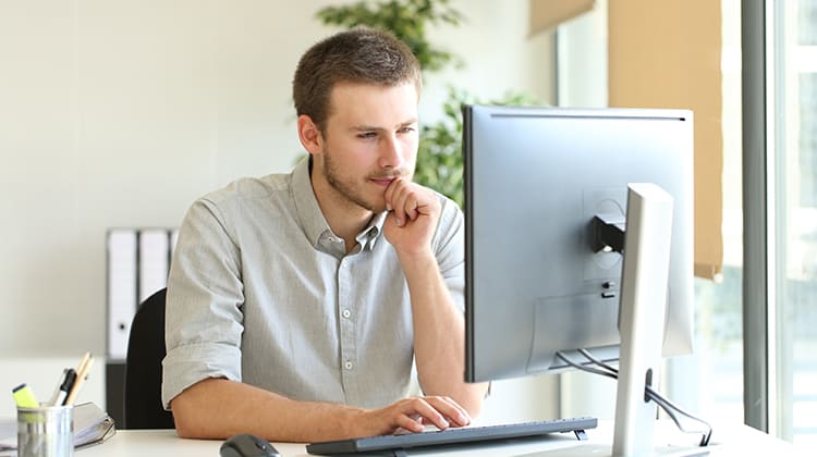 Concentrated businessman using computer at office